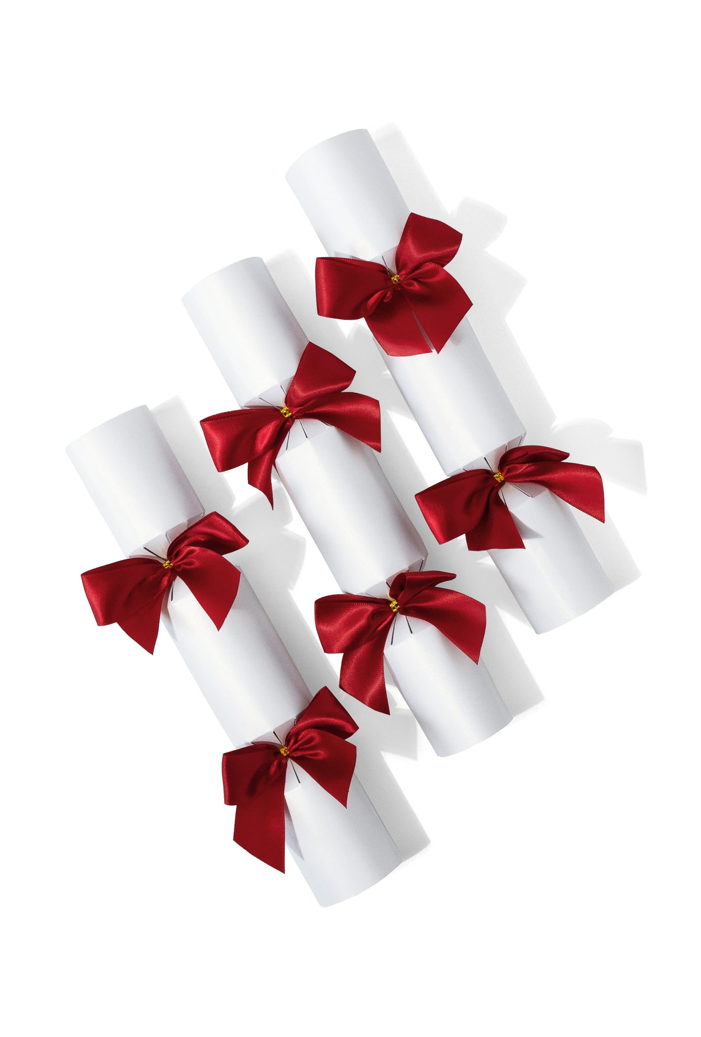 White Christmas crackers with red bows on a white background